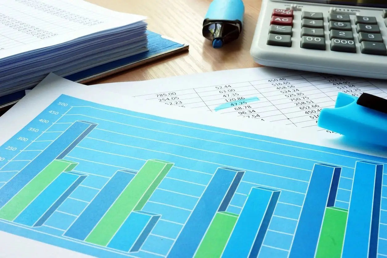 A table with papers and a calculator on it